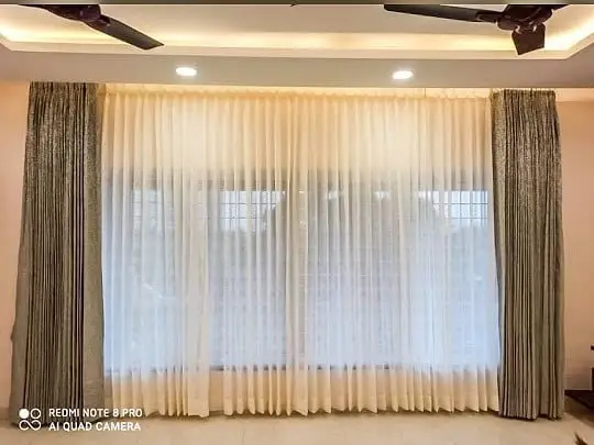 Layered sheer curtains with blackout drapery for bedroom privacy