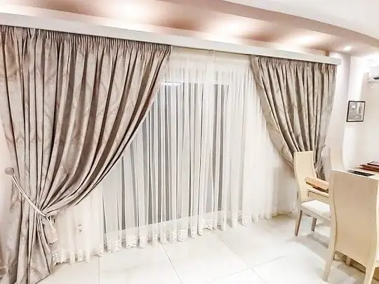 Luxury sheer curtains allowing soft daylight inside the room