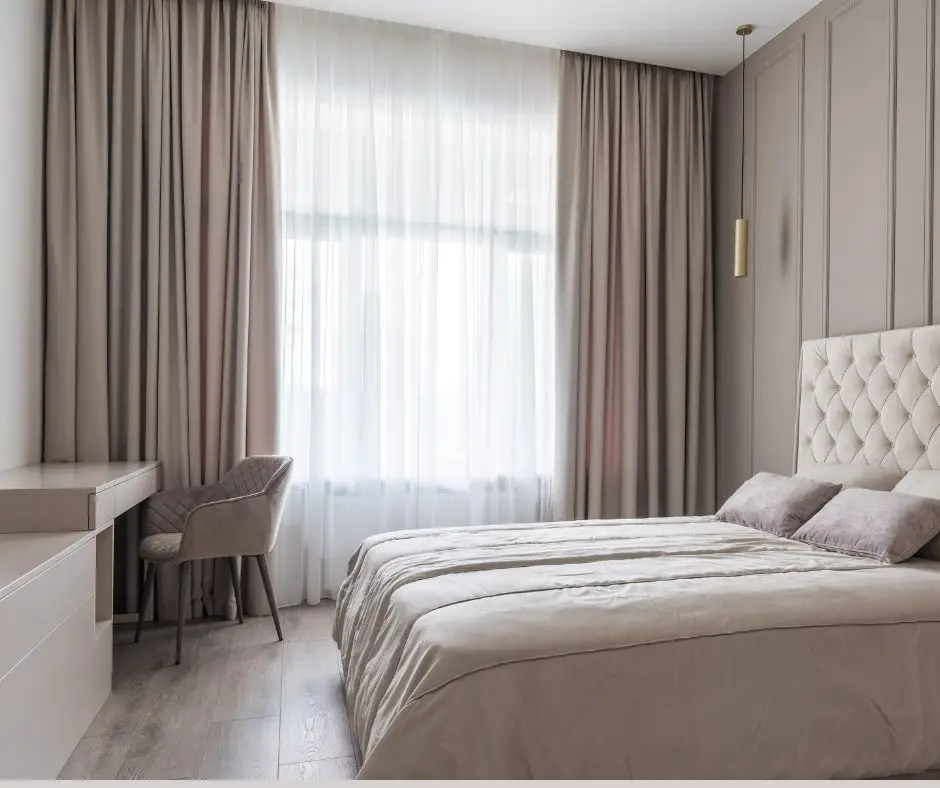 Elegant beige curtains with gold tassel tiebacks by Pune Decor